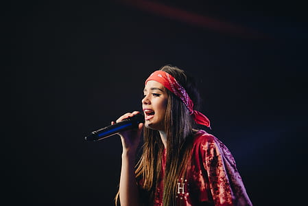 woman holding black wireless microphone thumbnail