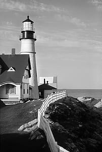 White and Black Lighthouse Near Gray Body of Water thumbnail