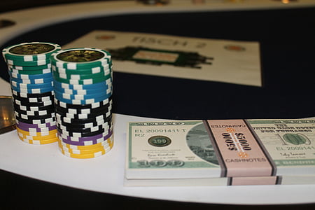US dollar stacks beside poker chips thumbnail