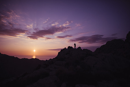 person standing on rock formation thumbnail