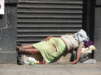 person sleeping beside rolling door thumbnail