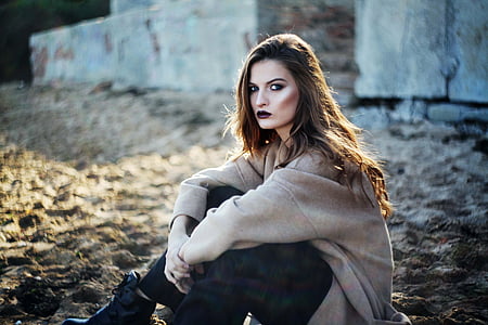 woman wearing gray sweatshirt sitting on the ground thumbnail