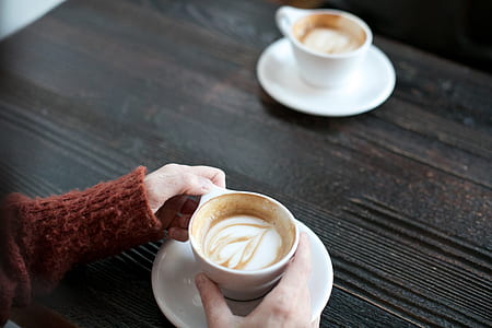 person holding teacup with liquid thumbnail