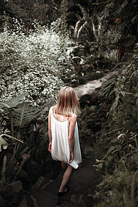 woman wearing white spaghetti strap walking down towards river thumbnail