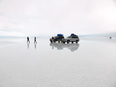 two black and gray vehicles parked on body of water at daytime thumbnail