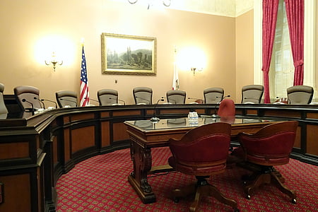 two brown wooden rolling armchairs in front of desk thumbnail