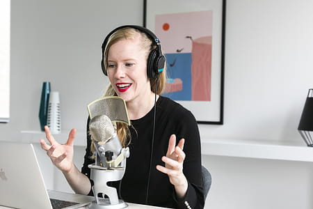 Woman Recording Podcast At Mic Photo thumbnail