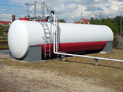 white and red storage tank during day thumbnail