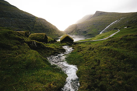 body of water surrounded by mountain thumbnail