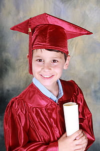 boy wearing red academic gown with mortar board thumbnail