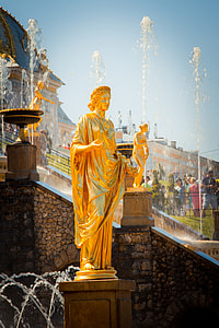 brown female standing statue near fountain thumbnail