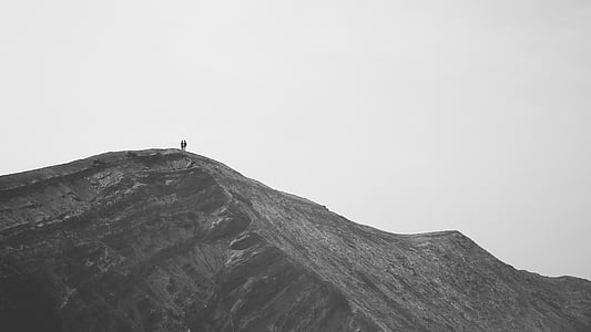 two people standing on rock formation thumbnail