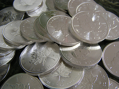 selective focus photography of stack of round silver-colored coin lot thumbnail
