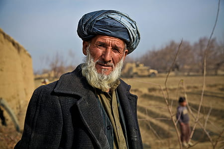 shallow focus photography of a man wearing black trench coat during daytime thumbnail