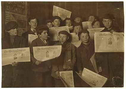 boy holding newspaper thumbnail