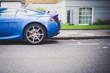 blue coupe on asphalt road near sidewalk thumbnail