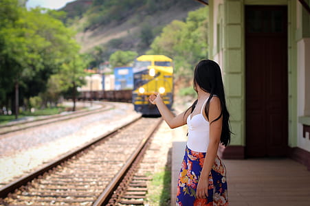 woman standing near railway thumbnail