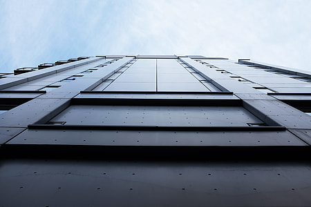 low angle photography of building under white clouds and blue sky thumbnail