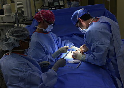 three person wearing blue hospital gowns thumbnail
