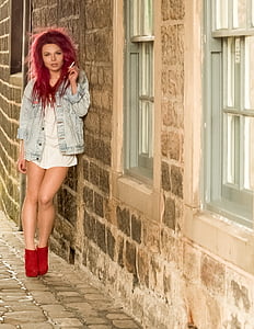 woman smoking cigarette leaning on wall thumbnail