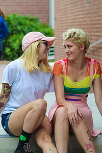 Two Women Sitting While Talking Each Other thumbnail