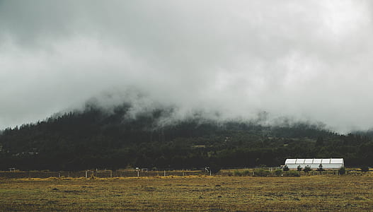 white concrete house near mountain thumbnail