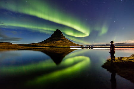 man looking at Northern lights thumbnail