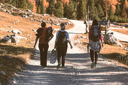three person walking on road thumbnail