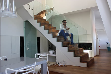 man sitting on stair inside well-lit room thumbnail