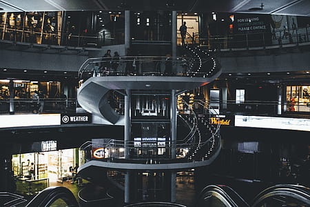 people inside building with spiral staircase thumbnail