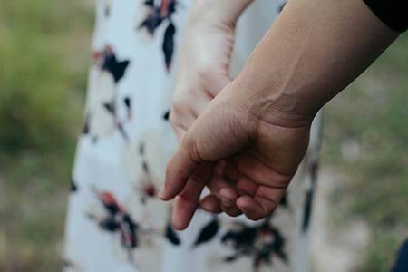 focused photo of a person's right and left hand thumbnail