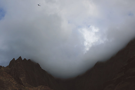 mountain range under cloudy sky thumbnail