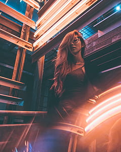 woman leaning on brown wall thumbnail