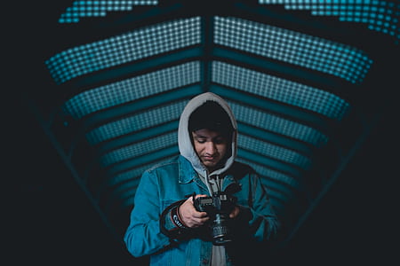 man holding DSLR camera thumbnail