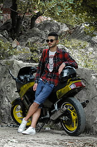 Man in Black Sunglasses Leaning Black Sportbike thumbnail