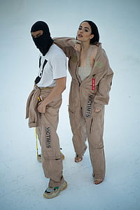 woman and man wearing brown coverall suits thumbnail