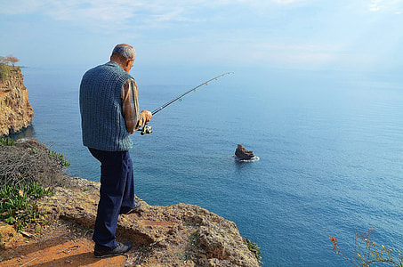 man fishing on mountain cliff thumbnail
