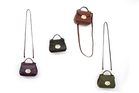 four assorted-color leather 2-way tote bags on white surface thumbnail