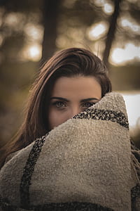 woman covering its face with knit textile thumbnail