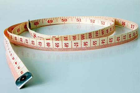 white measuring tape on teal surface thumbnail