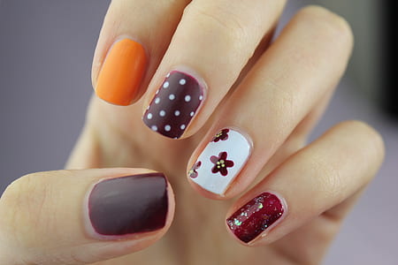 selective focus photography of assorted colored nail art thumbnail