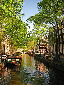 brown boat beside concrete road during daytime thumbnail