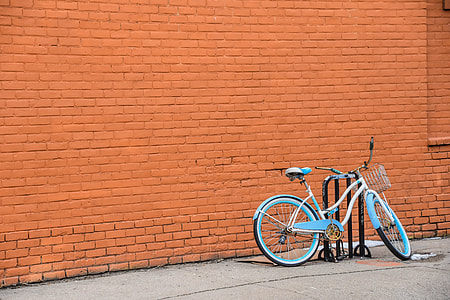 blue and white cruiser bike parked on sidewalk thumbnail
