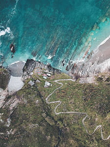 aerial photography of rocky seashore thumbnail