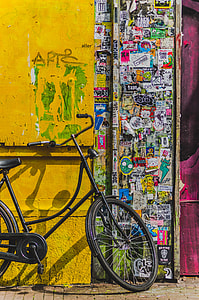black city bicycle on yellow wall thumbnail