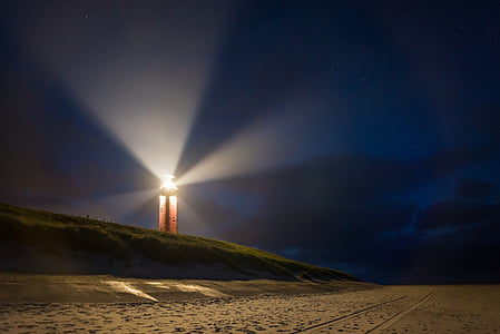 lighthouse near beach with ray of lights thumbnail