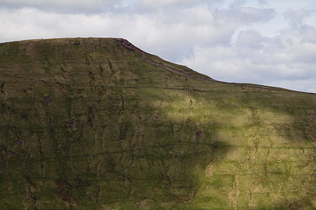 hill under cloudy sky thumbnail