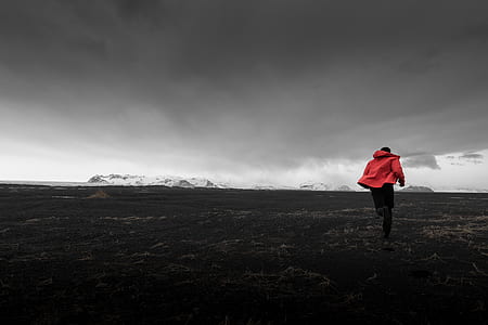 man in orange jacket under cloudy sky thumbnail