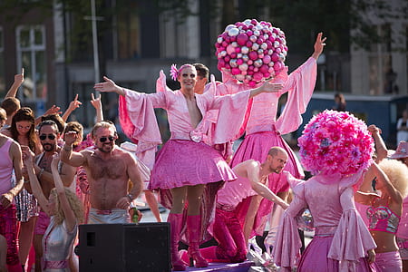 people wearing pink suits on parade outdoors thumbnail