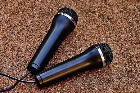 two black microphones on brown pagement thumbnail